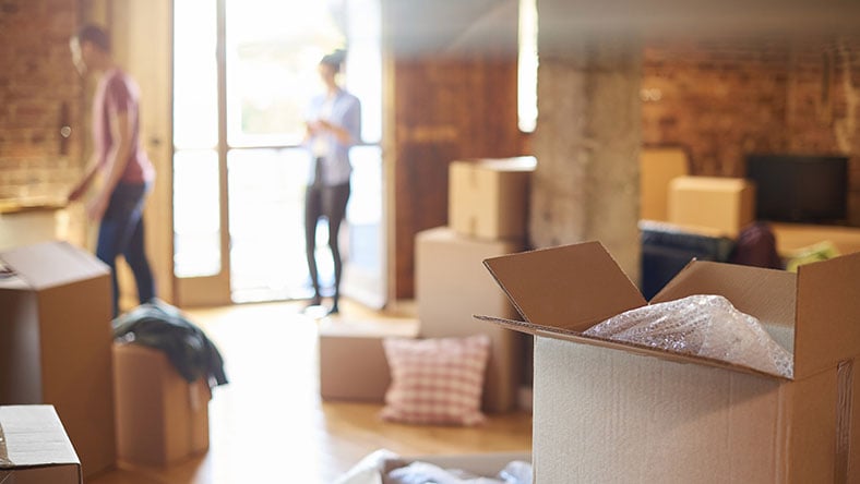 A couple unpacking boxes in a house