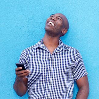 Young man holding phone lookup up